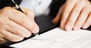 businessman signing a document