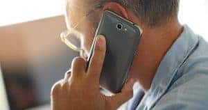 man with smart phone up to ear