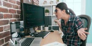 woman looking at computer in shock