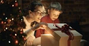 Boy and his mother opening Christmas gifts