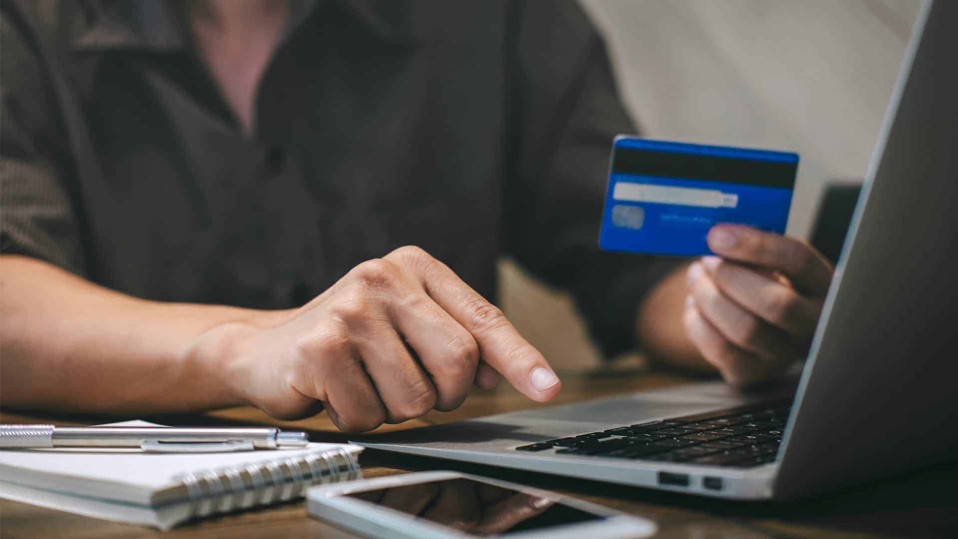 person holding credit card to make payment