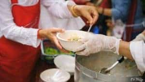image of hands giving food in food bank