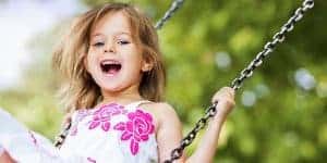 image of happy young girl on a swing