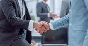 two businessmen shake hands