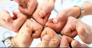 group of business people’s hands gathered together with thumbs up