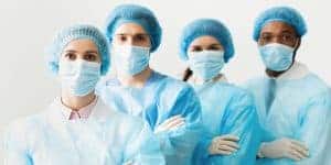 Surgeons Team Wearing Protective Uniforms, Standing In Row