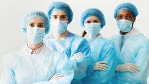 Surgeons Team Wearing Protective Uniforms, Standing In Row
