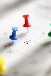 Pins pointing on a specific dates on a calendar