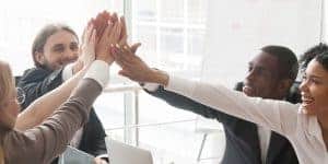 Image of business people giving a group high five