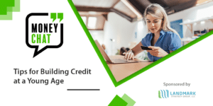 blonde woman holding credit card and using laptop