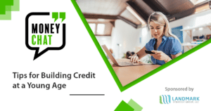 blonde woman holding credit card and using laptop