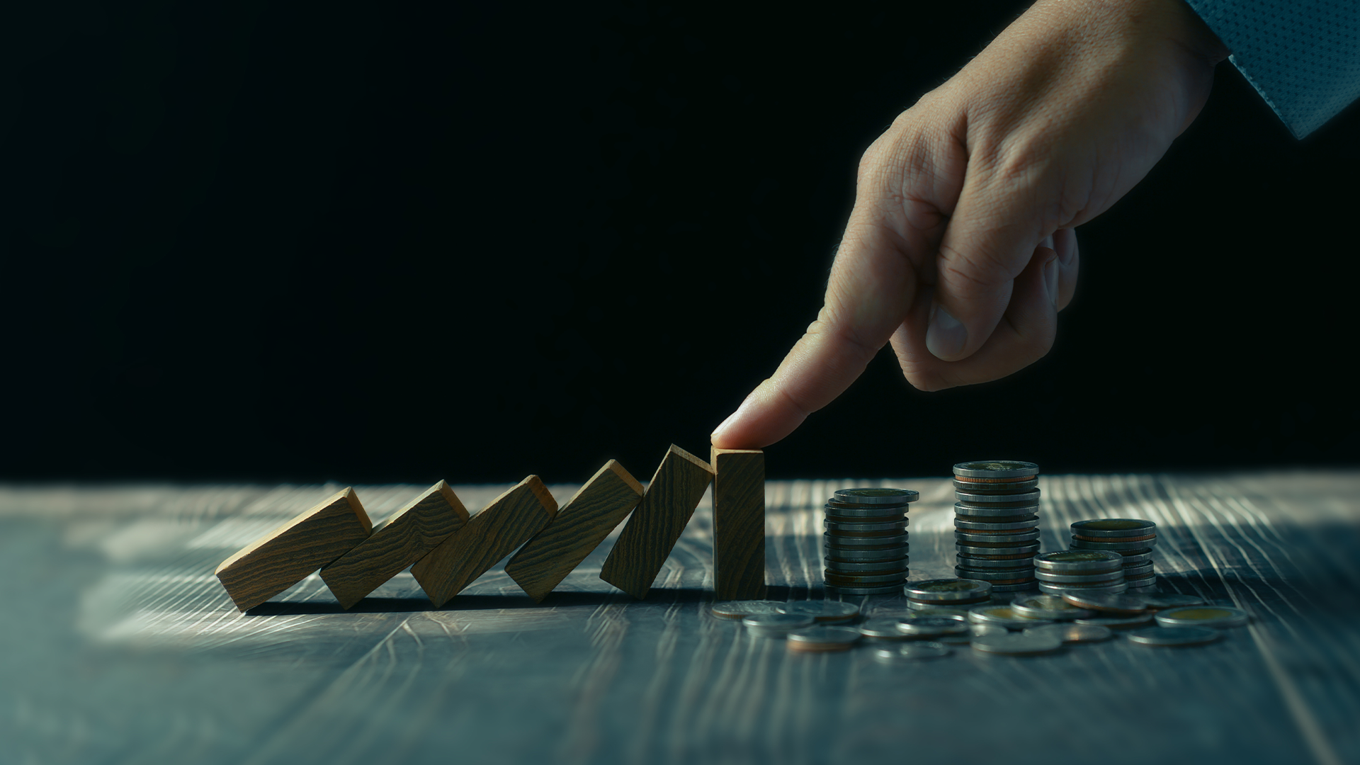 Economic collapse concept, hands stop domino crisis effect, financial and banking problems, recession, financial crisis, bad debt, inflation and interest rates, asset safety