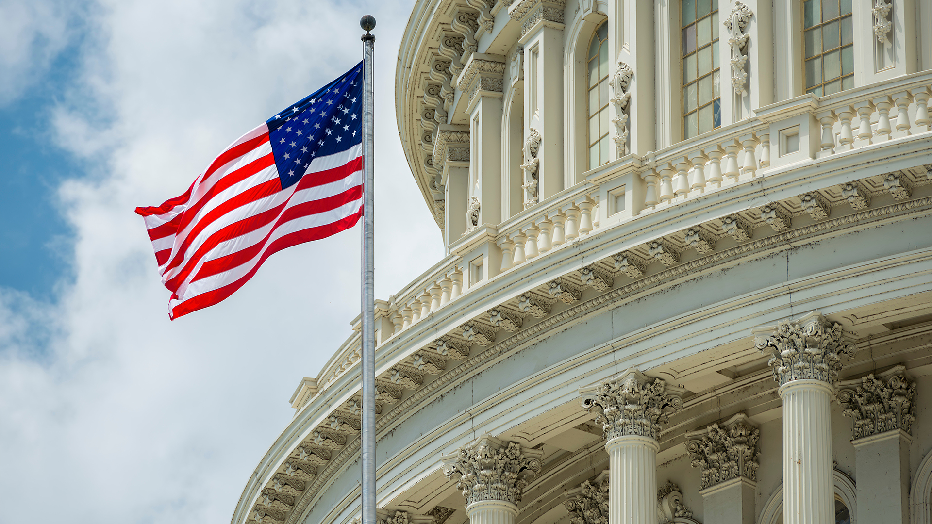 Washington DC Capitol dome detail with waving american flag