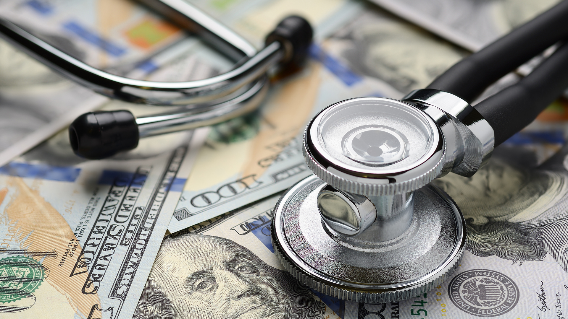 Medical stethoscope and dollar bills